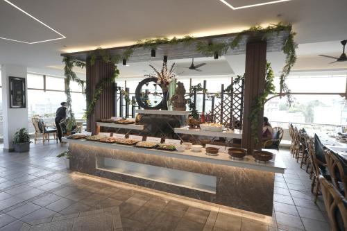a buffet in a restaurant with food on display at Maurya Rajadhani in Trivandrum