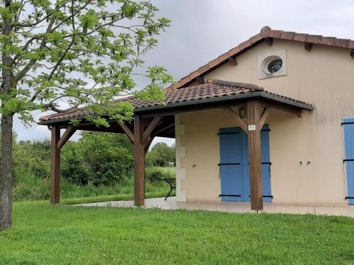 a wooden pergola on the side of a house at Villa in Les Forges near Golf Course in Les Forges