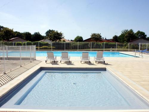 a pool with lounge chairs and a swimming pool at Villa in Les Forges with Golf & Pool Access in Les Forges