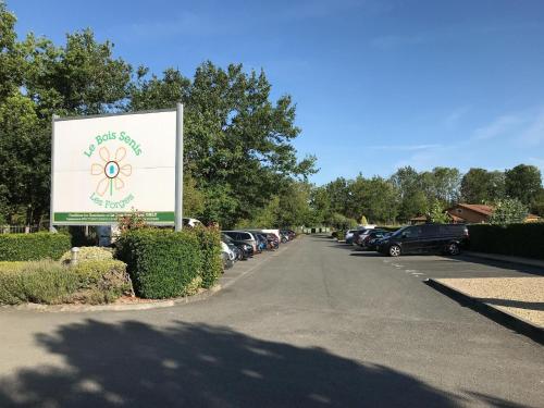 a sign in a parking lot with cars parked at Villa in Les Forges with Golf and Pool in Les Forges
