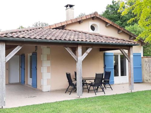 a pavilion with chairs and a table on a patio at Villa in Les Forges with Golf and Pool in Les Forges