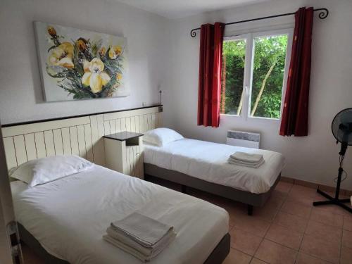a bedroom with two beds and a window with red curtains at Villa in Les Forges with Golf & Pool Access in Les Forges
