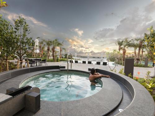 a man in a swimming pool at a resort at Hyatt Regency Seragaki Island Okinawa in Onna