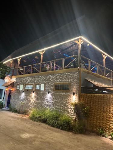 a stone building with lights on top of it at Dive Villa Thoddoo in Thoddoo