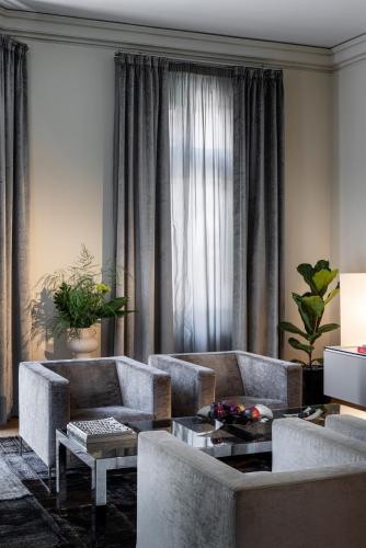 a living room with two couches and a table at The Nest by Juno Hotel Sofia in Sofia