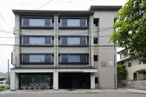 a building with bikes parked in front of it at Hotel Arashiyama in Kyoto