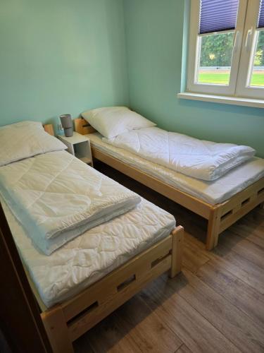 Postel nebo postele na pokoji v ubytování DOMKI#ENERGY Zator