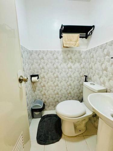 a small bathroom with a toilet and a sink at La Prima - The Perfect Urban Oasis in Santa Rosa