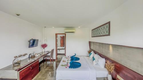 a room with a bed and a sink in it at The Calm Oasis in Siem Reap