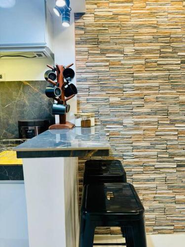 a counter in a kitchen with a black stool at La Prima - The Perfect Urban Oasis in Santa Rosa