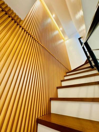 a stair case with brown and white stairs and wooden panels at La Prima - The Perfect Urban Oasis in Santa Rosa