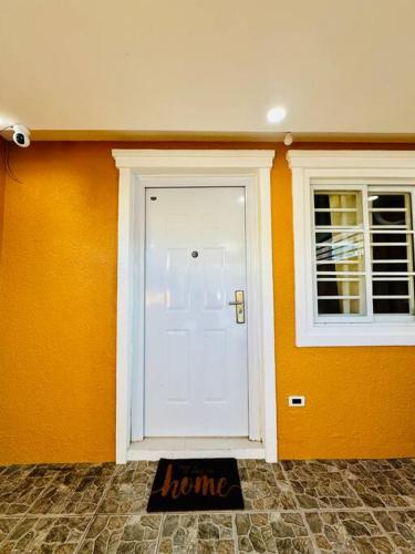 a white door with a window and a welcome mat at La Prima - The Perfect Urban Oasis in Santa Rosa