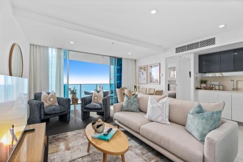 a living room with a couch and a table at H-Residences - Gclr in Gold Coast