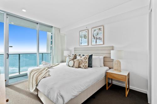 a bedroom with a large bed and a large window at H-Residences - Gclr in Gold Coast
