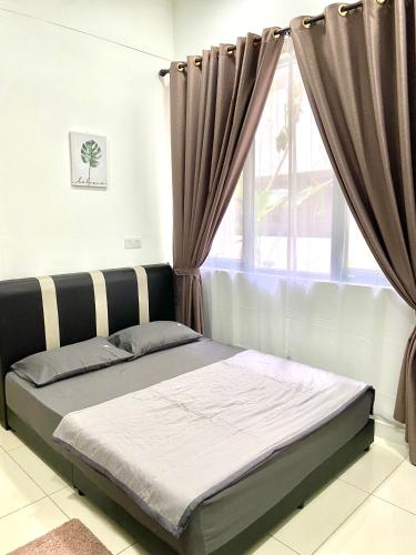 a bed in a room with a window at MiriTimesSquare DAJ#3 FREE WiFi in Miri