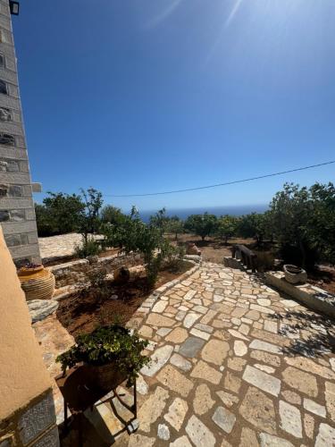 a stone walkway with a view of the ocean at Refoulo Tower in Poliána