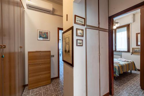 a hallway with a room with a bed at Annamaria's House 200m From Sea - Happy Rentals in Viareggio