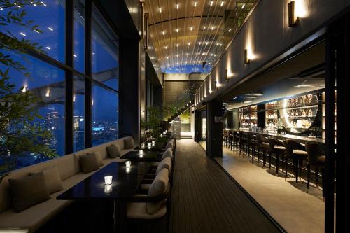 a restaurant with couches and tables in a building at Aiden by Best Western Cheongdam in Seoul