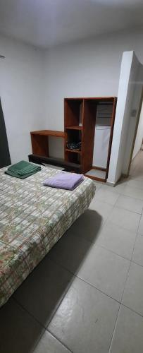 a room with a bed and a dresser in it at Complejo Caroya in Colonia Caroya