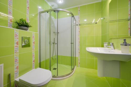a green bathroom with a shower and a sink at Queen's view 14-Pools-Near Botanic garden in Balchik