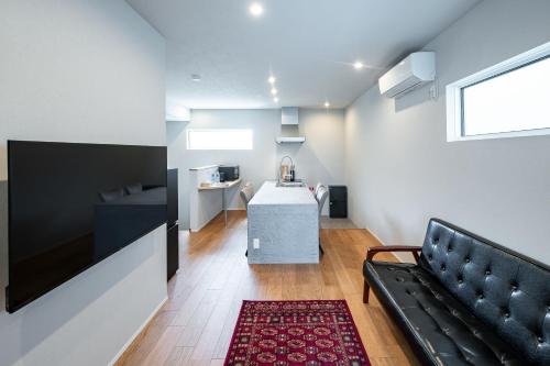 a living room with a couch and a table at BATEAU rental vacation in Awaji