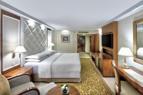 a hotel room with a bed and a television at Islamabad Marriott Hotel in Islamabad