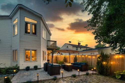 a backyard patio with furniture and a fence at sunset at Patio Paradise Stylish 3BR Home with Gaming Room in Arlington