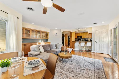 a living room with a couch and a table at Patio Paradise Stylish 3BR Home with Gaming Room in Arlington