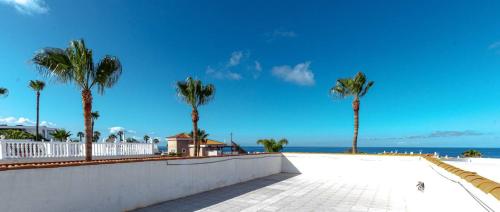 a view of the beach and palm trees at Villa Victoria With Heated Pool in Callao Salvaje