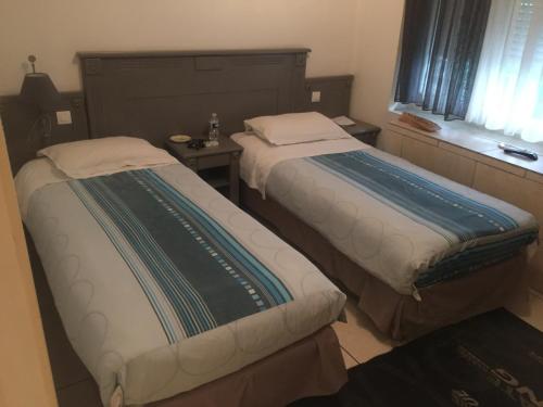 Кровать или кровати в номере Hôtel de l'Europe