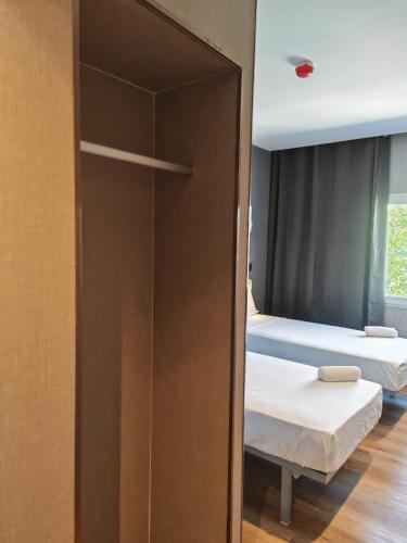 a door to a room with two beds in a room at Hotel Golden Alcorcon in Alcorcón