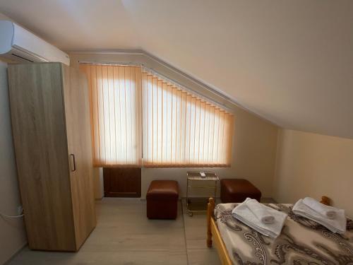 a bedroom with a bed and a window with at Анелия in Sapareva Banya