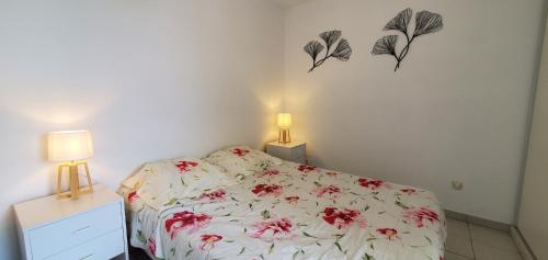 a bedroom with a bed and two lamps on the wall at Port Frejus, 100 m des plages, le CESAREE, T2 30m2 in Fréjus