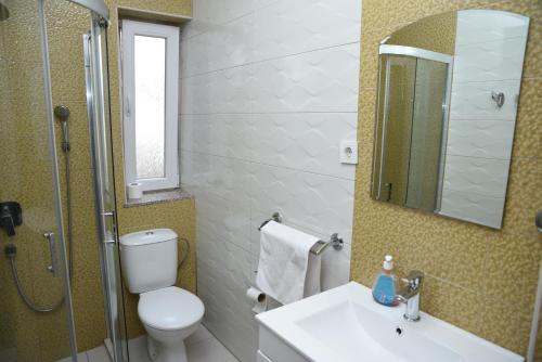 a bathroom with a toilet and a sink and a shower at Rooms Filip in Bitola