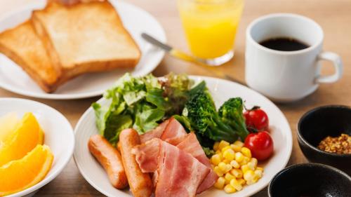 a table with plates of food and a cup of coffee at JR East Hotel Mets Premier Tokyo Bay Shinkiba in Tokyo