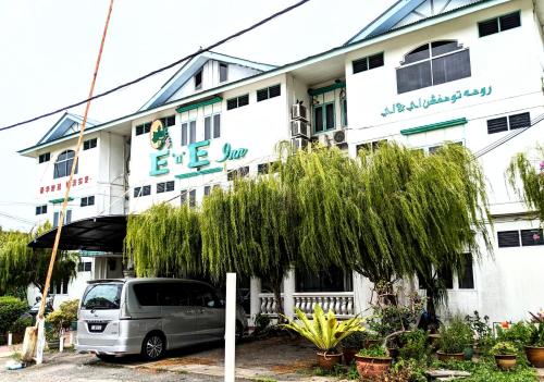 a van parked in front of a white building at EnE Sri Cemerlang in Kota Bharu