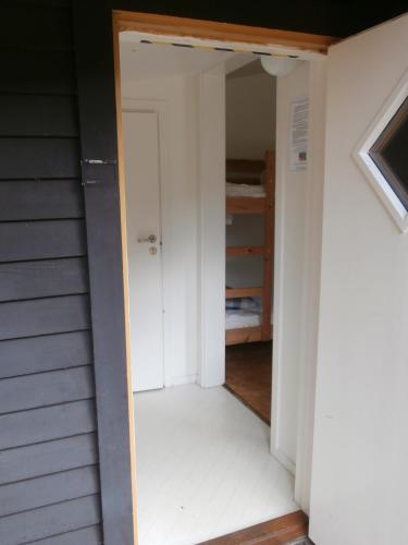 an open door into a room with a closet at Tylebäck - boende med självhushåll in Halmstad
