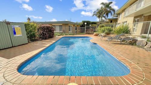 a swimming pool in the backyard of a house at The Essentials Unit 2 - 1 Marine Parade in Merimbula