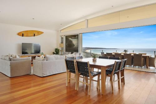 a living room with a table and chairs at Short Point Quarters - Whole House in Merimbula