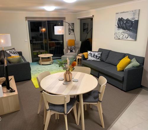 a living room with a table and a couch at Higgi Drive 1 Ski-In Ski-Out in Mount Hotham
