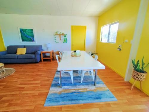 a living room with a white table and chairs at 2 bedroom farm stay in Metricup at Qwack's Farm in Metricup
