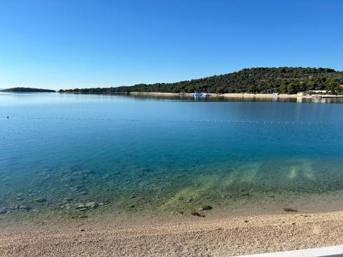 a large body of water with a sandy beach at Iris in Jezera