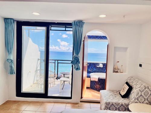 a living room with a view of the ocean at Rockhand Homestay in Eluan