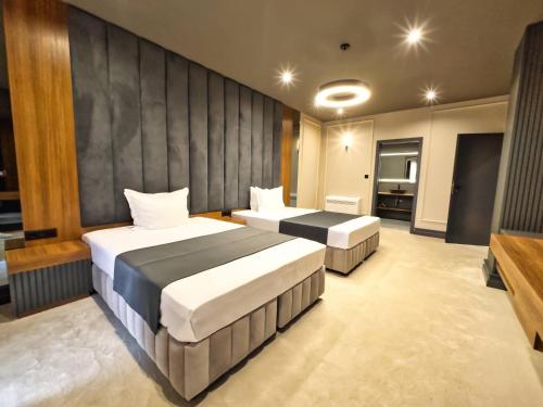 Ένα ή περισσότερα κρεβάτια σε δωμάτιο στο VIGOR Hotel