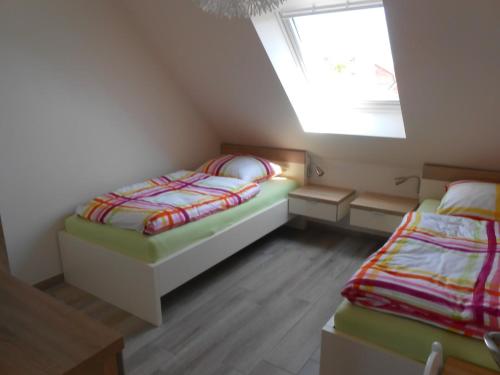 a bedroom with two beds and a window at Emsdüne in Borkum