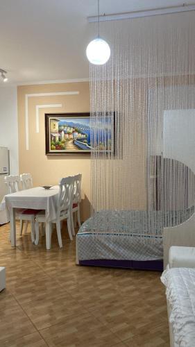 a dining room with a white table and chairs at Dori 's place in Vlorë