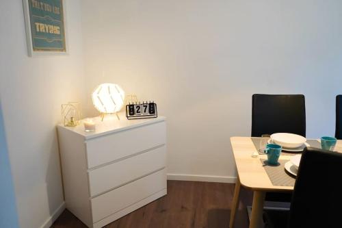 a dining room with a dresser and a table with a mirror at RM-1 - Joli 2 pièces tout équipé au 1er étage pour 1-3 pers in Mulhouse