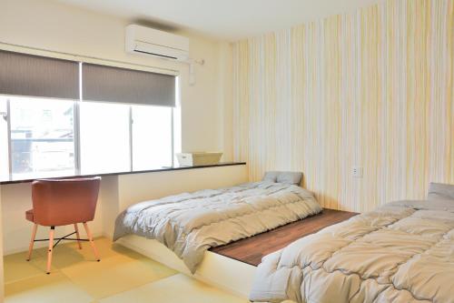 Postel nebo postele na pokoji v ubytování Hostelコトヒラクラスカ