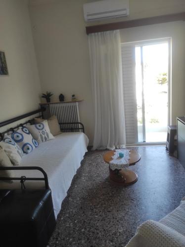 a living room with a bed and a coffee table at KROKOS HOUSE in Aliveri