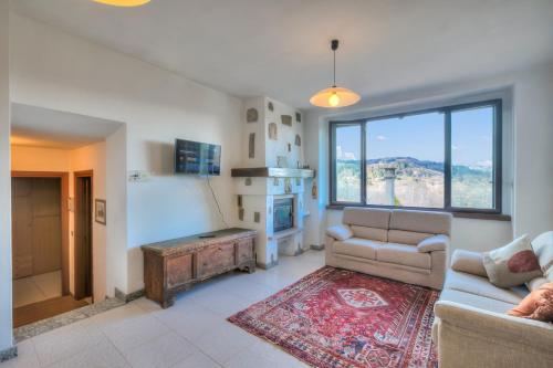 a living room with a couch and a table at Ortensia Blu Lake And Relax - Happy Rentals in Gignese